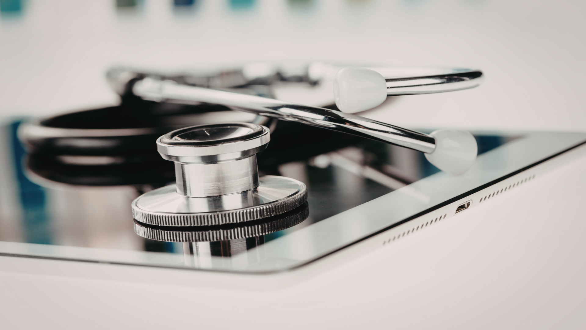 Welby Wellness stethoscope with a silver chest piece resting on a tablet, representing Concierge Healthcare and medical care, with a clean, clinical aesthetic